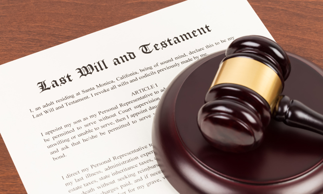 Last will and testament on yellowish paper with wooden judge gavel